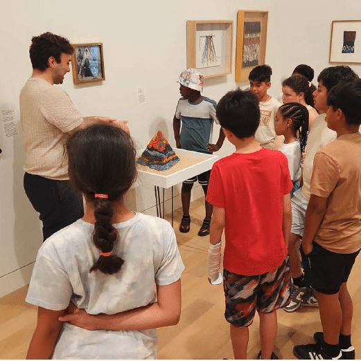 Children looking at an object in museum